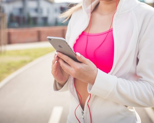 Woman listening to podcast for exercising